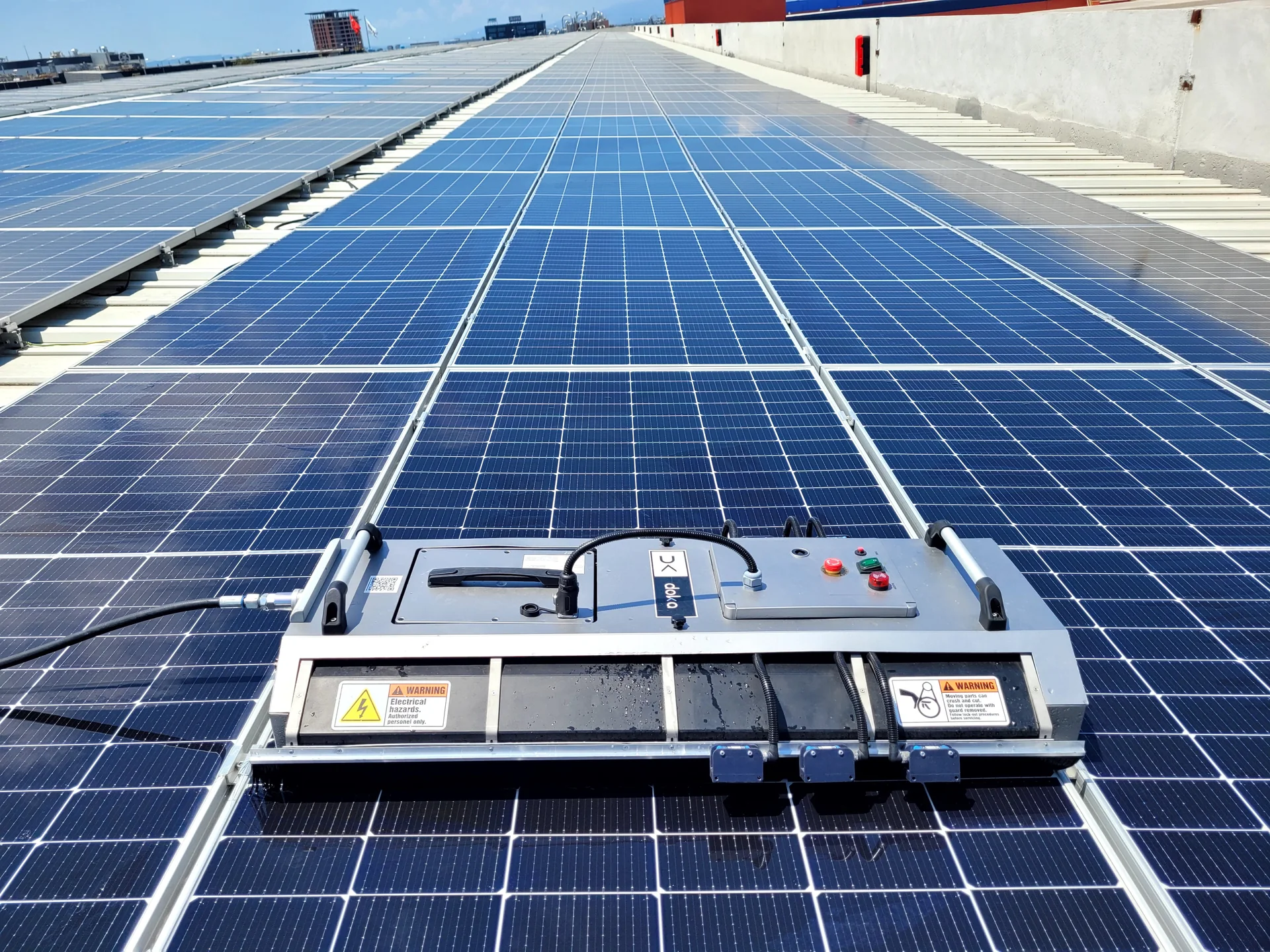 Solar panel cleaning robot performing automatic PV cleaning on a utility-scale solar farm