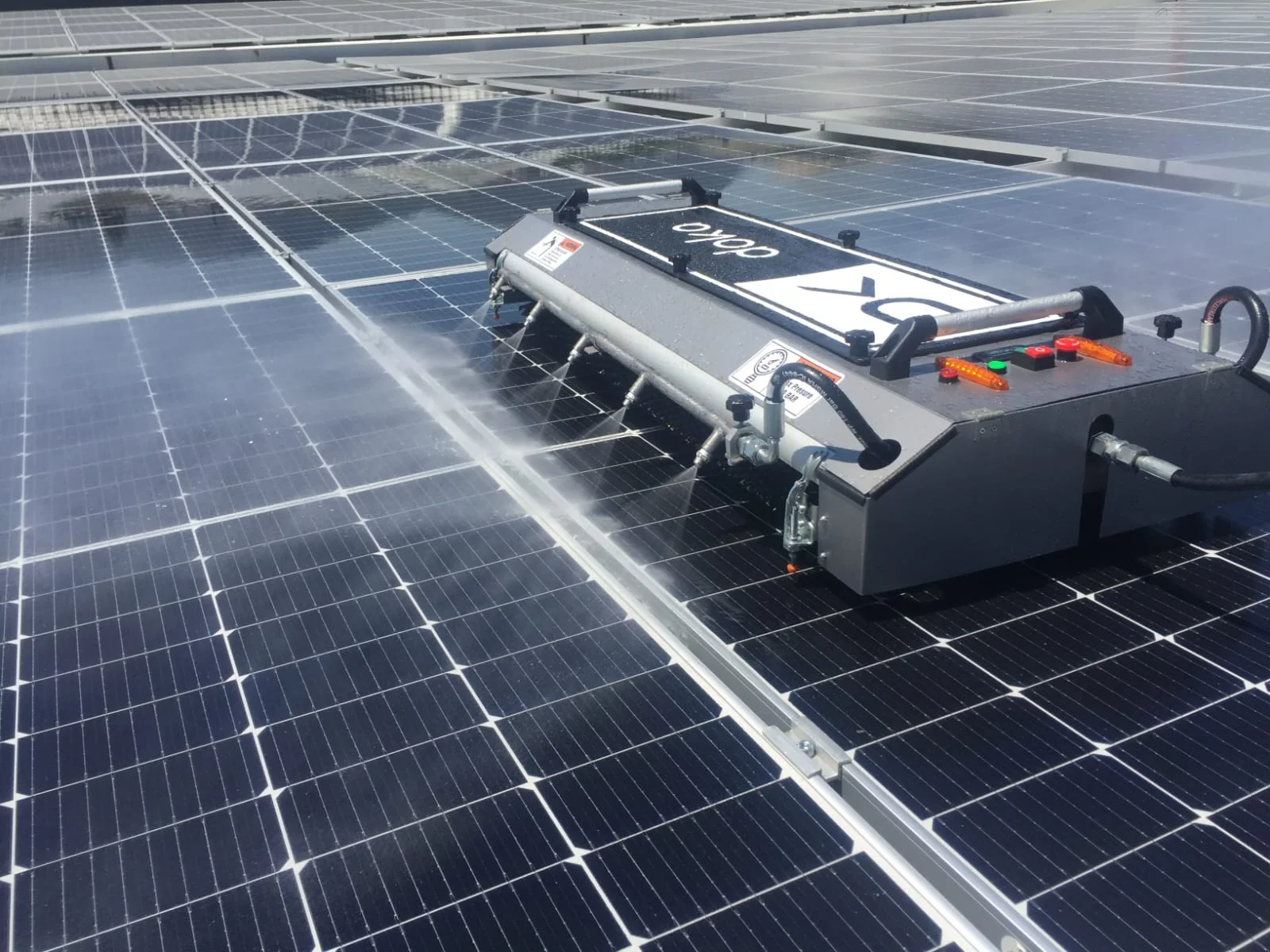 FK-1000-V2 solar panel cleaning robot in wet mode on a rooftop PV plant